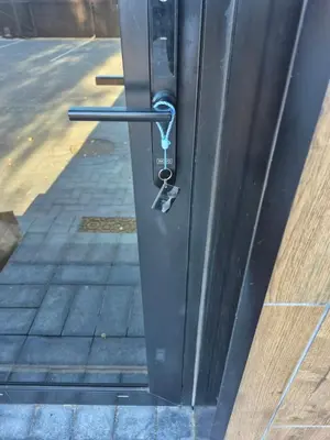 a metal door with a key on the side of a building at Marių namai in Kaunas