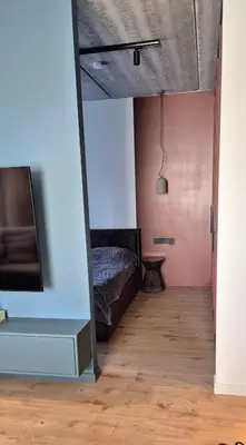 a bedroom with a bed and a tv in a room at Cozy 3-Room Flat by Twinsbet Arena & Ozas in Vilnius