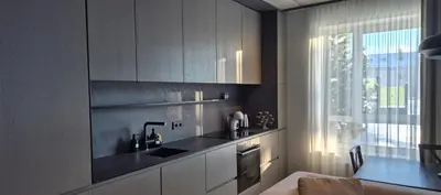 a kitchen with white cabinets and a sink and a window at Cozy 3-Room Flat by Twinsbet Arena & Ozas in Vilnius