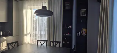 a dining room with a table and a window at Cozy 3-Room Flat by Twinsbet Arena & Ozas in Vilnius