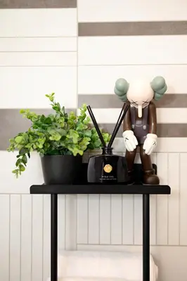 a table with a plant and a statue on it at HYPE Apartments in Kaunas