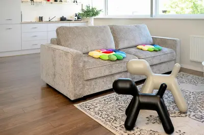a living room with a couch and a chair at HYPE Apartments in Kaunas