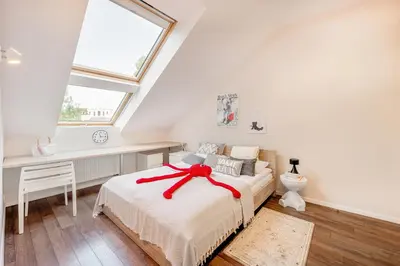 a bedroom with a bed with a red ribbon on it at HYPE Apartments in Kaunas