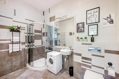 a bathroom with a shower toilet and a sink at HYPE Apartments in Kaunas