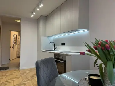 a kitchen with a glass table and a sink at Cozy Apartment Near Forest in Kaunas