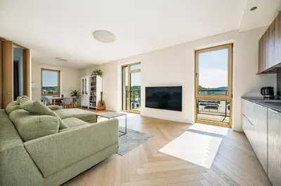 a living room with a couch and a tv at Modern city center apartment in Vilnius