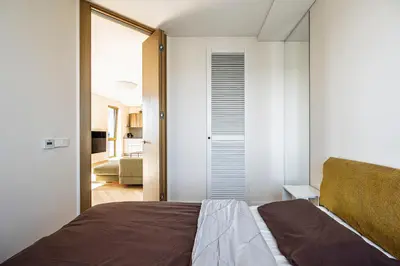 a bedroom with white walls and a bed in a room at Modern city center apartment in Vilnius