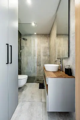 a bathroom with a sink and a toilet and a mirror at Modern city center apartment in Vilnius