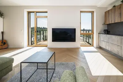 a living room with a tv and a couch at Modern city center apartment in Vilnius