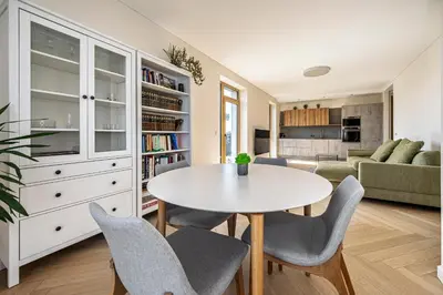 a living room with a white table and chairs at Modern city center apartment in Vilnius