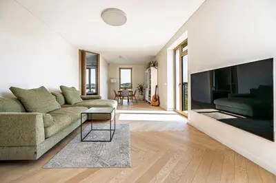 a living room with a couch and a large tv at Modern city center apartment in Vilnius