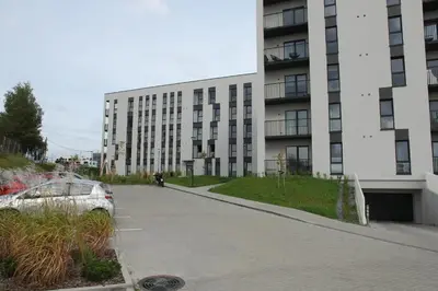 a car parked in front of a building at Warmzy Home - Modern Flat with Free Parking in Vilnius