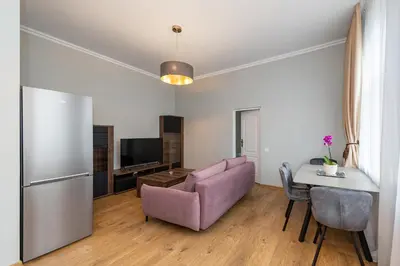 a living room with a couch and a table at Elegant city center apartment with free parking by Polo Aparments in Kaunas