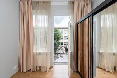 a hallway with curtains and a large window at Elegant city center apartment with free parking by Polo Aparments in Kaunas