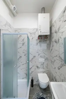 a bathroom with a shower and a toilet at Elegant city center apartment with free parking by Polo Aparments in Kaunas