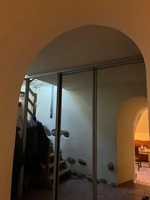 an archway with a glass shower in a room at The cave in Vilnius
