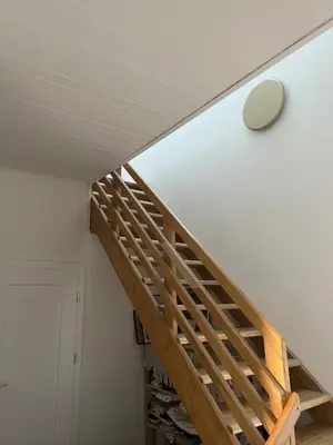 a staircase in a house with a clock on the wall at The cave in Vilnius