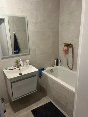 a bathroom with a sink and a bath tub and a mirror at The cave in Vilnius