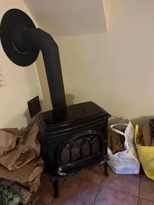 a black stove in the corner of a room at The cave in Vilnius