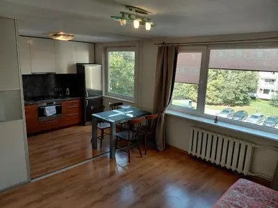 a kitchen with a table and chairs in a room at Two-Bedroom Flat Close to Downtown in Kaunas