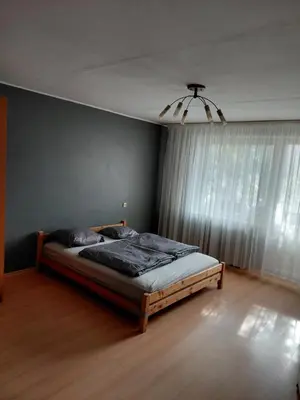 a bedroom with a bed in a room with a window at Two-Bedroom Flat Close to Downtown in Kaunas
