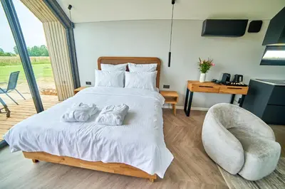 a bedroom with a bed with two towels on it at Oriana Resort