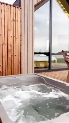 a jacuzzi tub in front of a house at Oriana Resort