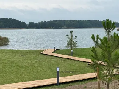 a wooden dock next to a large body of water at Oriana Resort