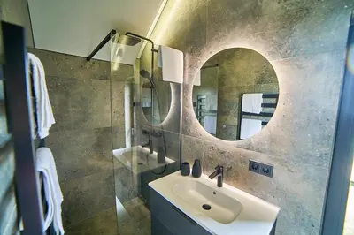 a bathroom with a sink and a mirror at Oriana Resort