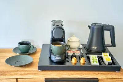 a coffee maker sitting on a counter with a cup of coffee at Oriana Resort