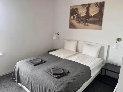 a bedroom with a bed with two towels on it at Arklių Pašto Stotis in Staškūniškis