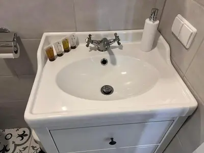 a white bathroom sink with three candles on it at Arklių Pašto Stotis in Staškūniškis