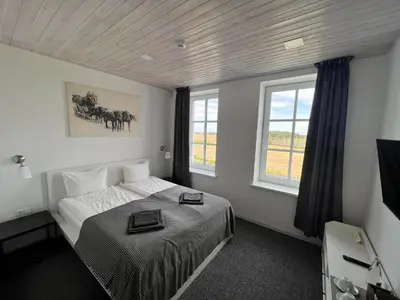 a bedroom with a bed with two plates on it at Arklių Pašto Stotis in Staškūniškis