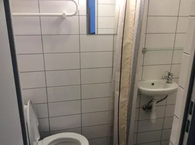a bathroom with a toilet and a sink at BHB Hotel in Marijampolė