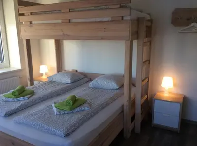 two bunk beds in a room with two green towels at BHB Hotel in Marijampolė