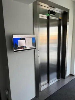 a elevator in a building with a sign on the wall at BHB Hotel in Marijampolė