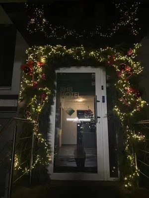a door to a shop with christmas lights at BHB Hotel in Marijampolė