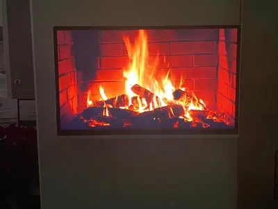 a fireplace with a tv in front of it at BHB Hotel in Marijampolė