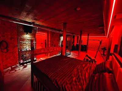 a bedroom with a bed in a red room at 69 apartaments BDSM in Panevėžys