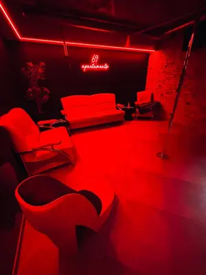 a red room with red chairs and a couch at 69 apartaments BDSM in Panevėžys