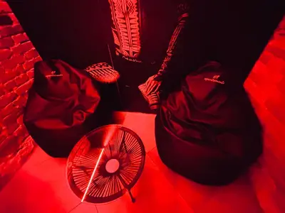 a red room with a fan and a bag and a fan at 69 apartaments BDSM in Panevėžys