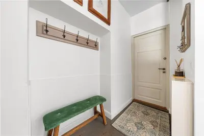 a hallway with a green bench next to a door at Užupio Sparnai in Vilnius