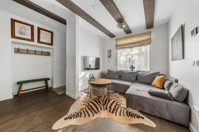 a living room with a couch and a zebra rug at Užupio Sparnai in Vilnius
