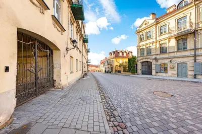 an empty street in a city with buildings at Užupio Sparnai in Vilnius