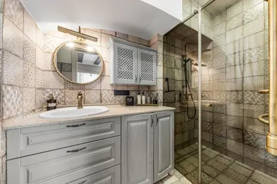 a bathroom with a sink and a shower at Užupio Sparnai in Vilnius