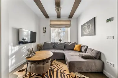 a living room with a couch and a table at Užupio Sparnai in Vilnius