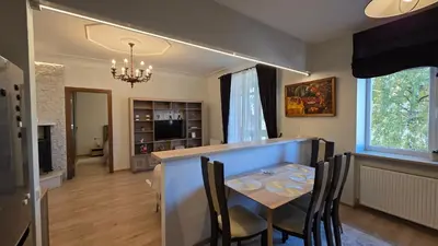 a kitchen and dining room with a table and chairs at Vytauto Apartments in Šiauliai