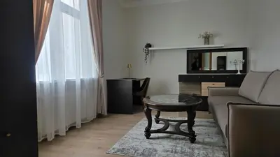 a living room with a couch and a table at Vytauto Apartments in Šiauliai