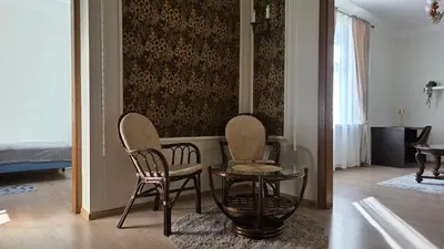 a living room with two chairs and a table at Vytauto Apartments in Šiauliai