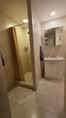a bathroom with a shower and a sink at Vytauto Apartments in Šiauliai